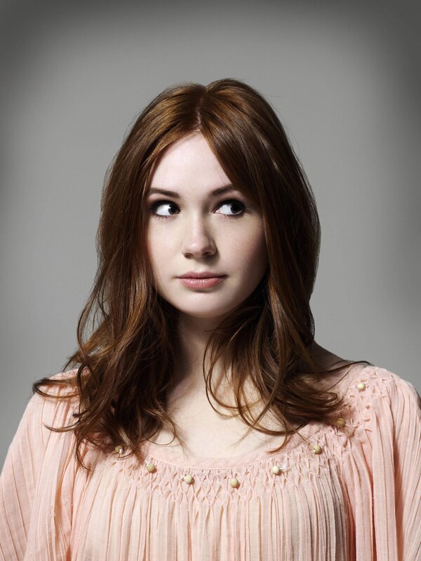 woman with brown hair in pink top