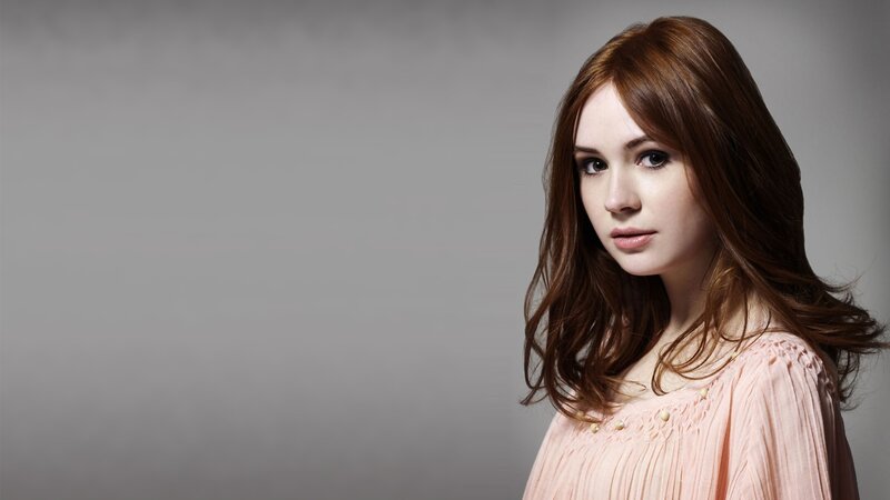 woman with brown hair in pink top