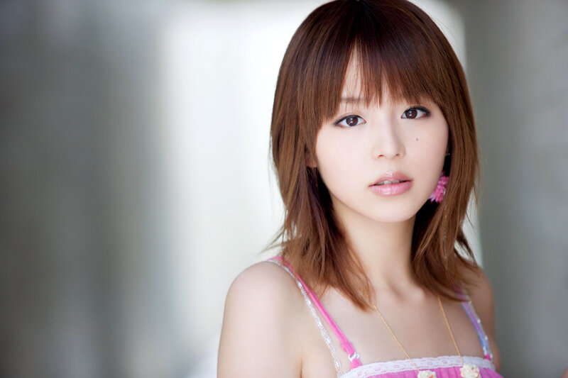 woman with brown hair in pink top