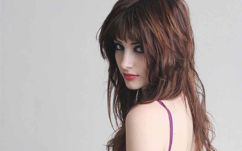 woman with brown hair in purple top