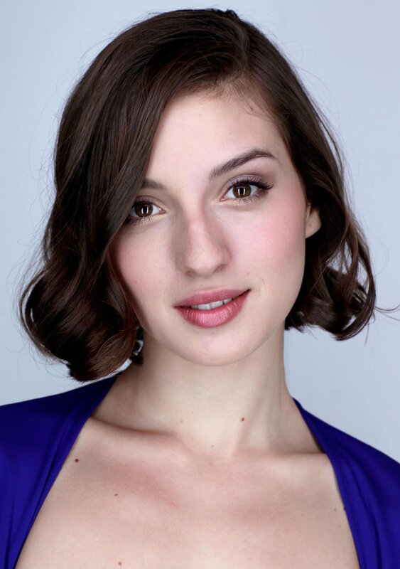 woman with brown hair in purple top