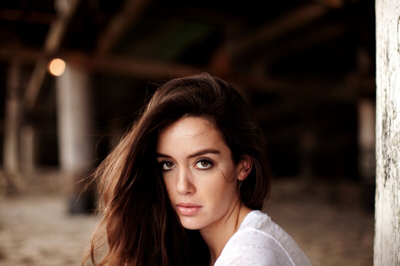 woman with brown hair in rustic setting