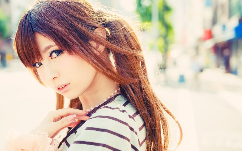 woman with brown hair in street