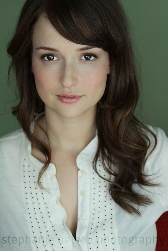woman with brown hair in white shirt