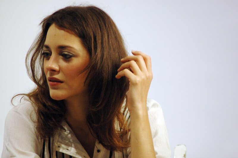 woman with brown hair in white shirt