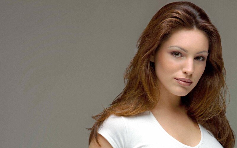 woman with brown hair in white shirt
