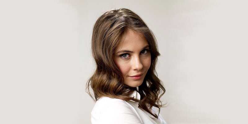 woman with brown hair in white shirt