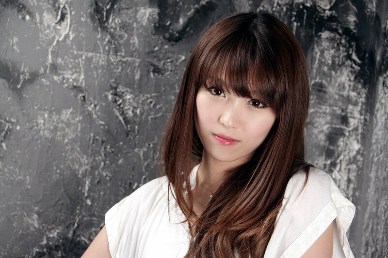 woman with brown hair in white shirt