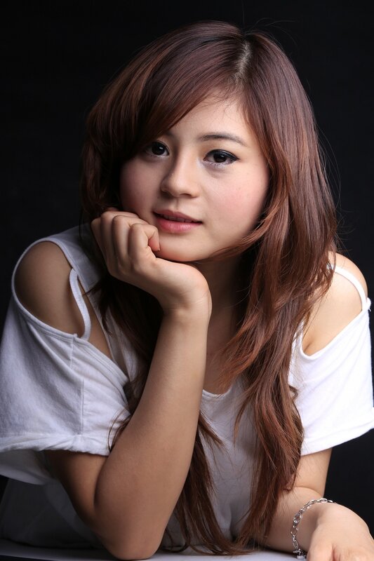 woman with brown hair in white top