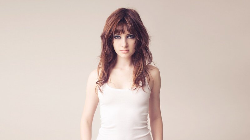 woman with brown hair in white top