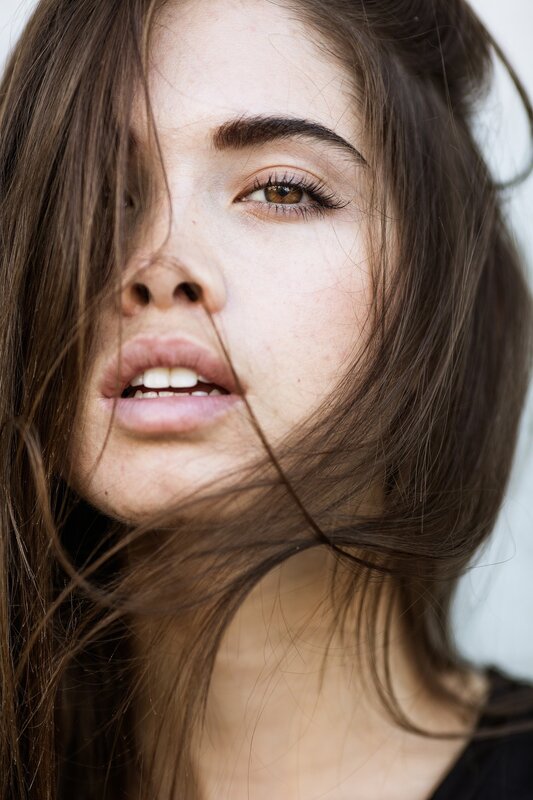 woman with brown hair in wind