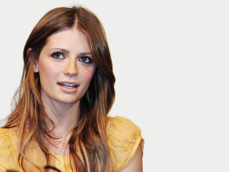 woman with brown hair in yellow top