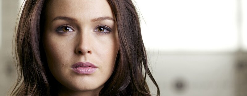 woman with brown hair looking at camera