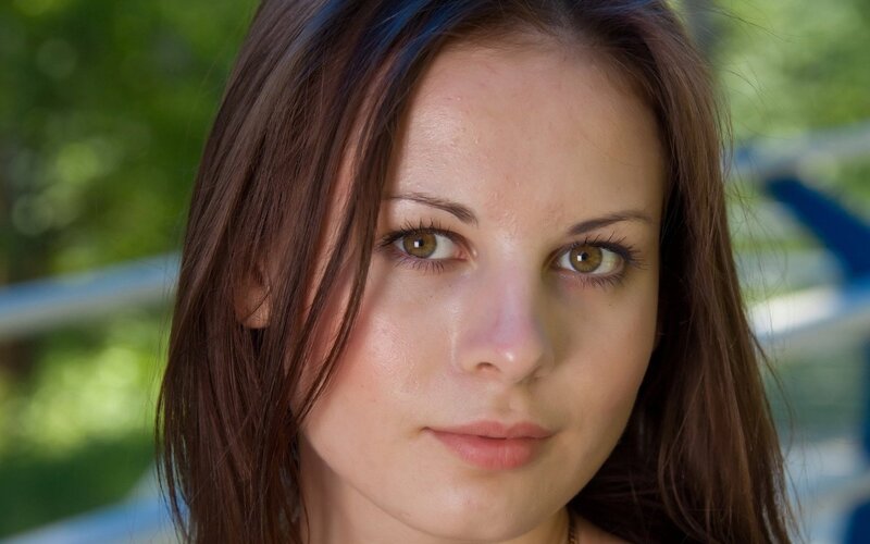 woman with brown hair looking at camera