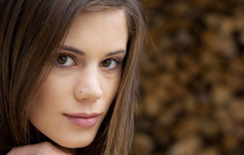 woman with brown hair looking at camera