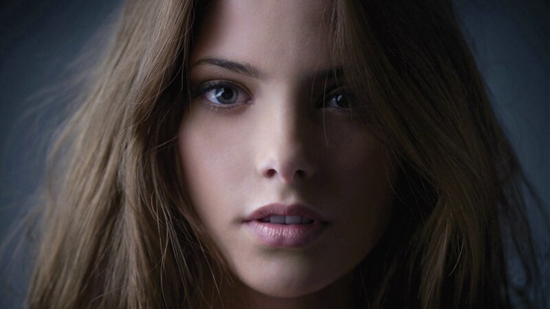 woman with brown hair looking at camera