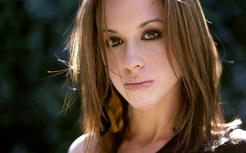 woman with brown hair looking at camera
