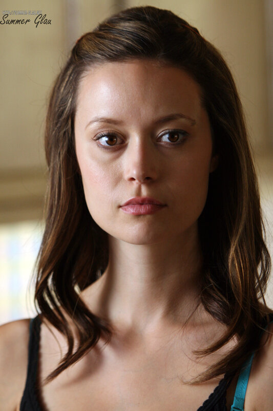 woman with brown hair looking at camera