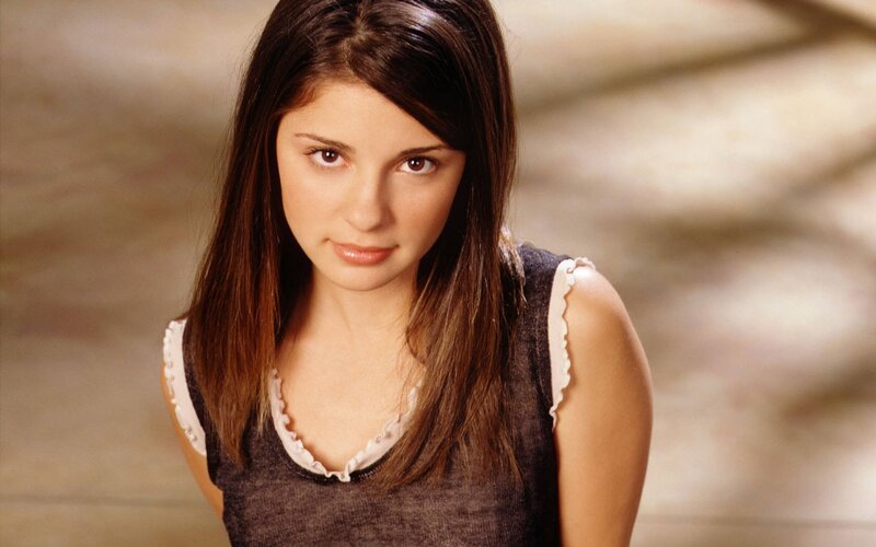 woman with brown hair looking at camera
