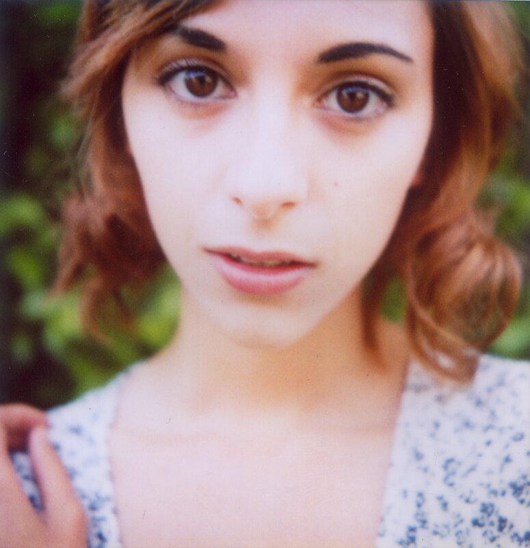 woman with brown hair looking at camera
