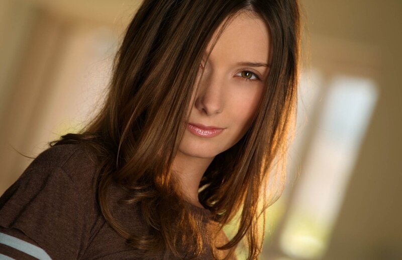 woman with brown hair looking at camera