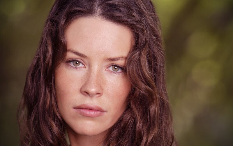 woman with brown hair looking at camera