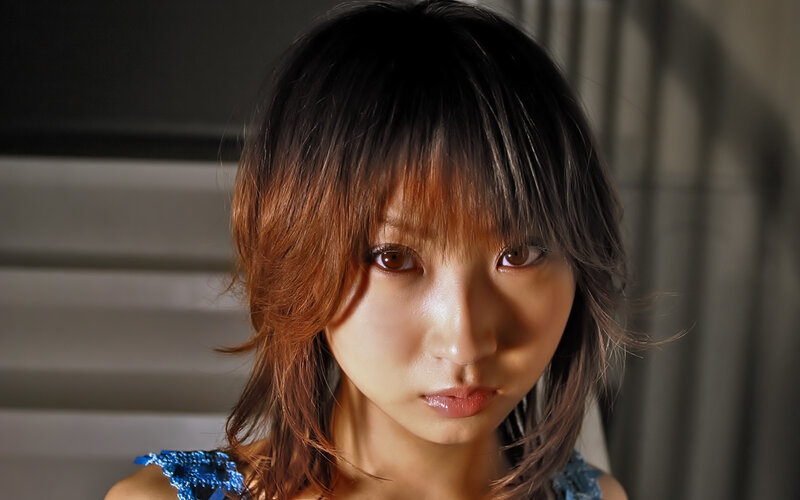 woman with brown hair looking at camera