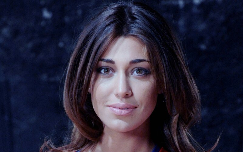 woman with brown hair looking at camera
