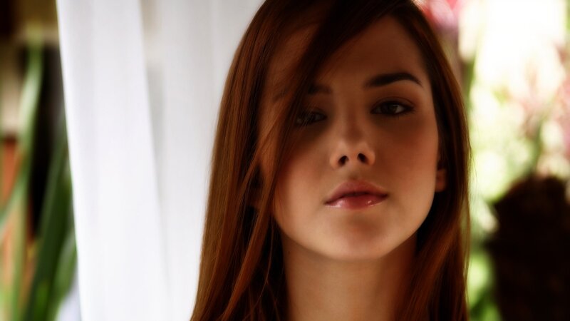 woman with brown hair looking at camera