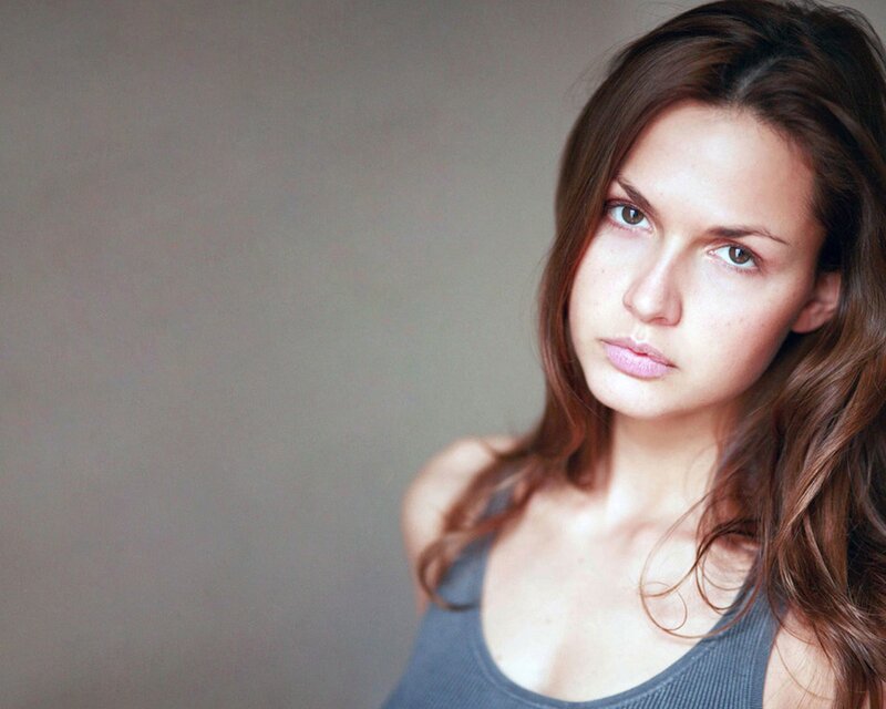 woman with brown hair looking at camera