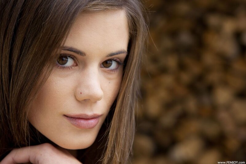 woman with brown hair looking at camera