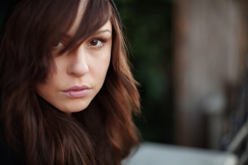 woman with brown hair looking at camera