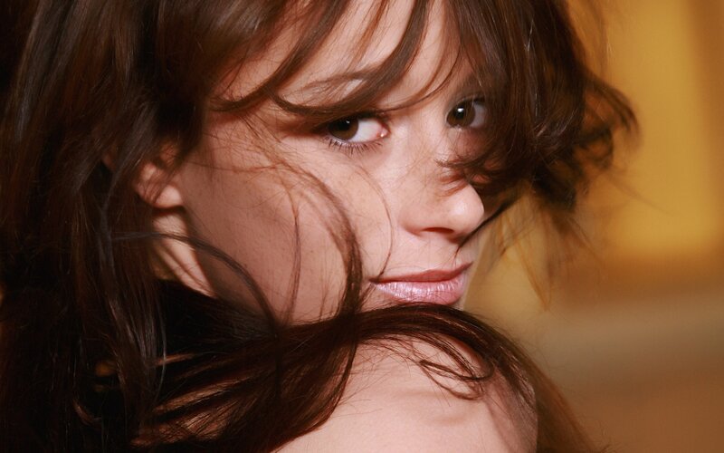 woman with brown hair looking at camera