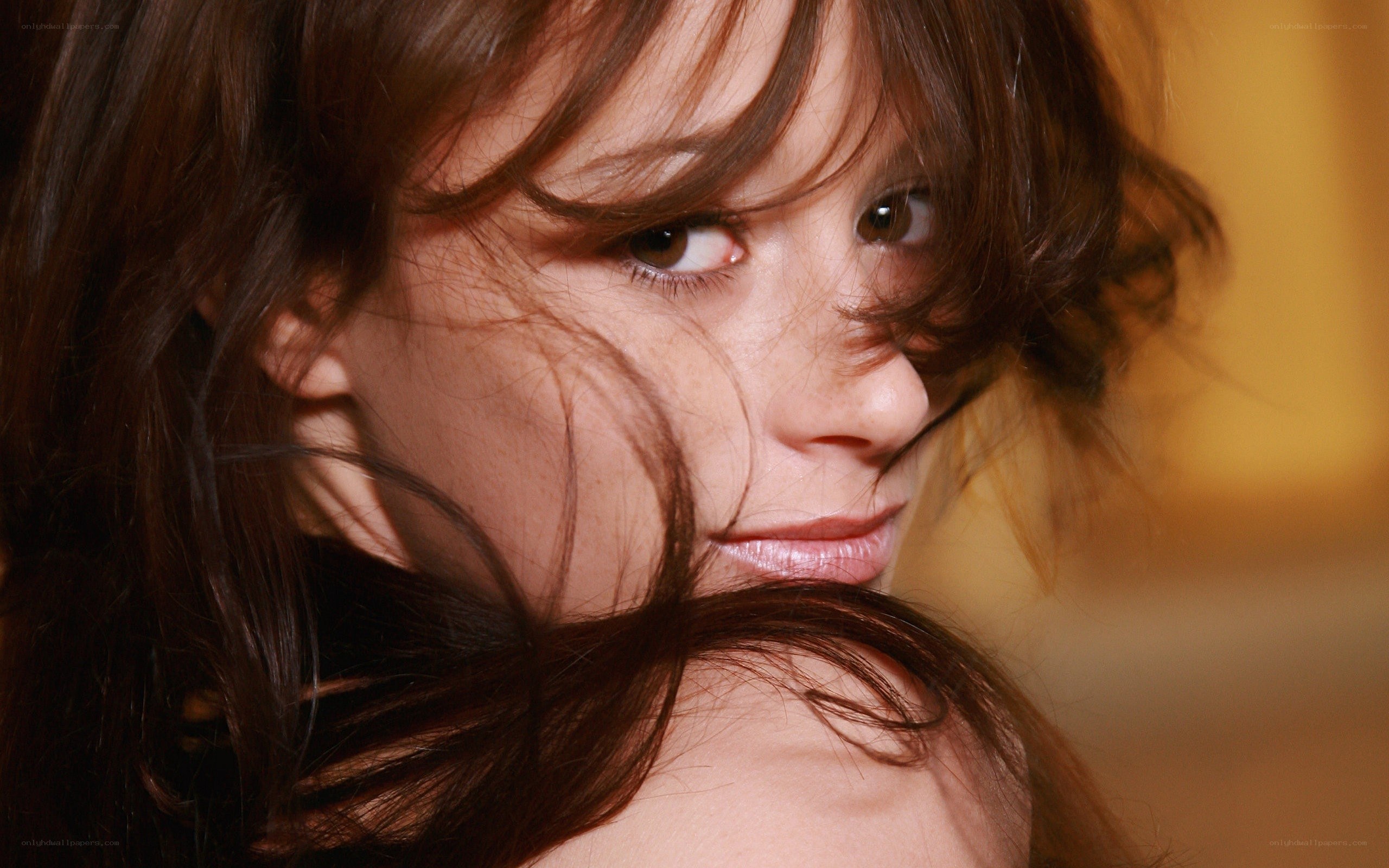 woman with brown hair looking at camera
