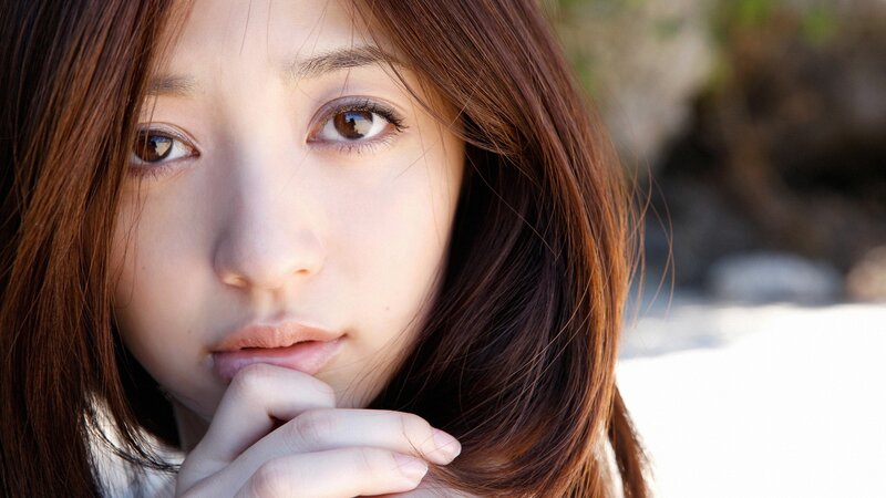 woman with brown hair looking at camera