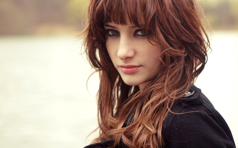 woman with brown hair looking at camera