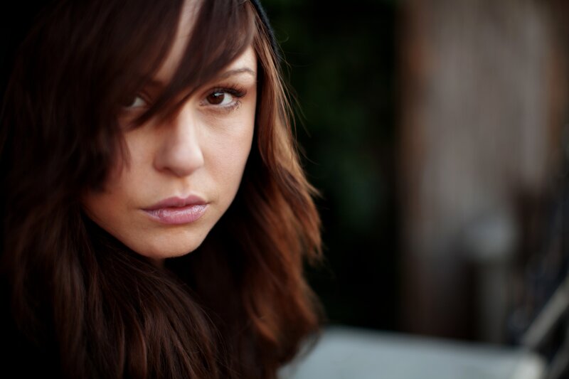 woman with brown hair looking at camera