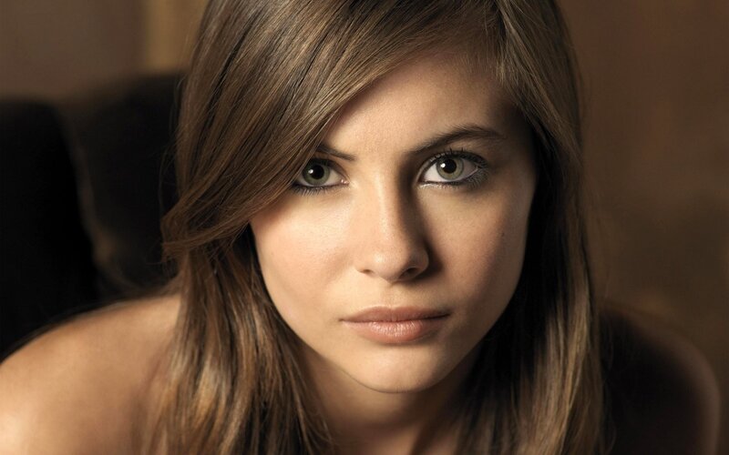 woman with brown hair looking at camera