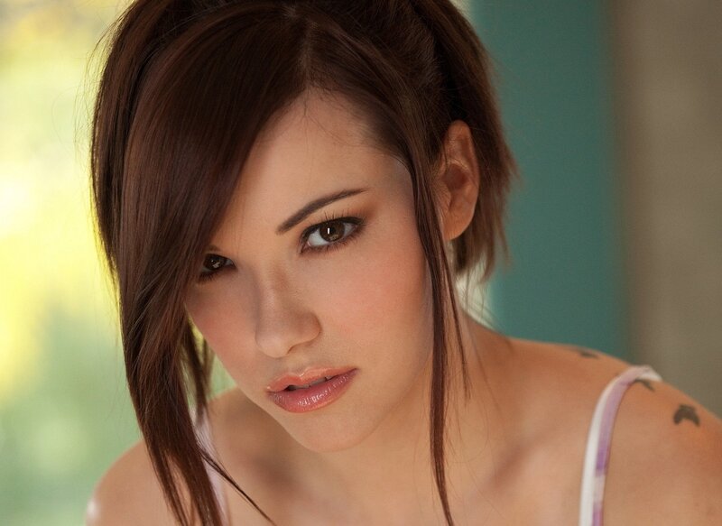 woman with brown hair looking at camera