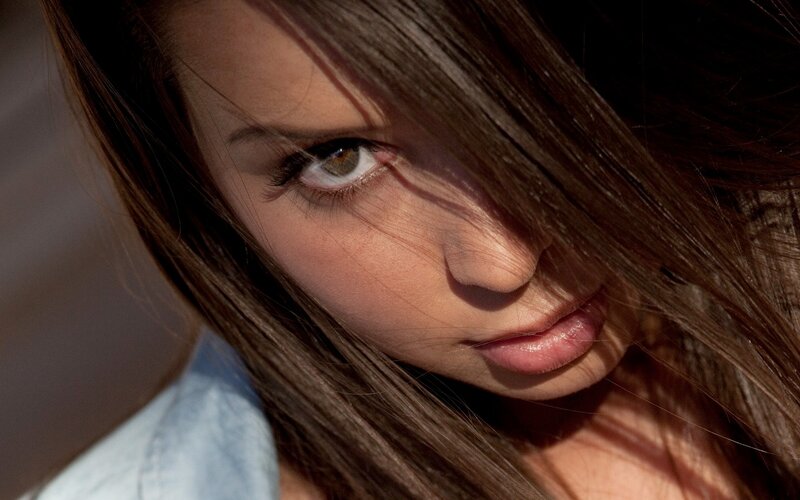woman with brown hair looking at camera