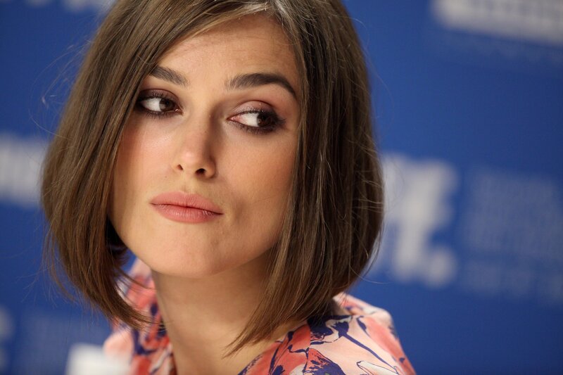 woman with brown hair looking away