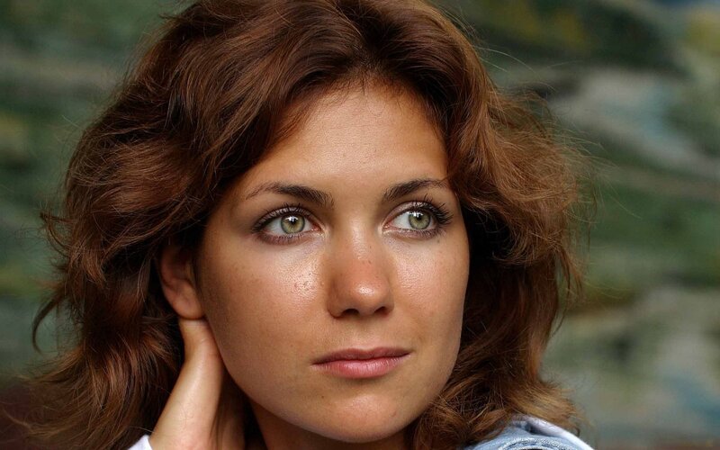 woman with brown hair looking away