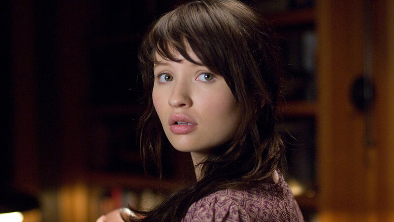 woman with brown hair looking back