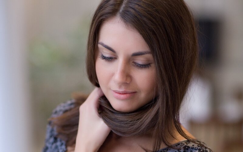 woman with brown hair looking down