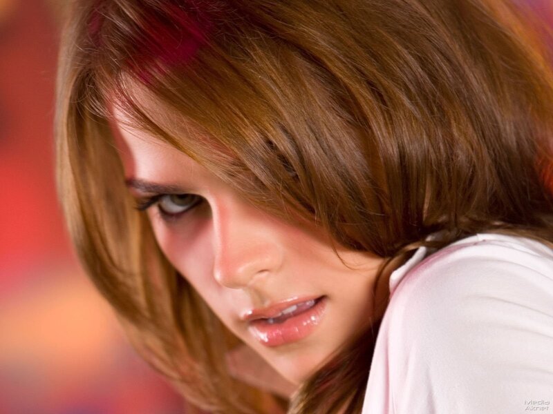 woman with brown hair looking down