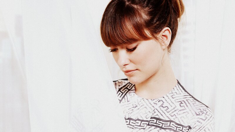 woman with brown hair looking down