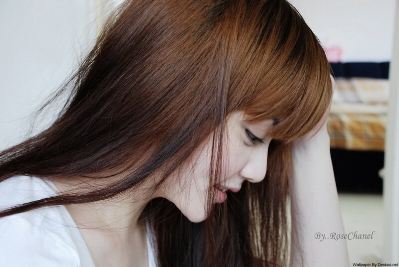 woman with brown hair looking down