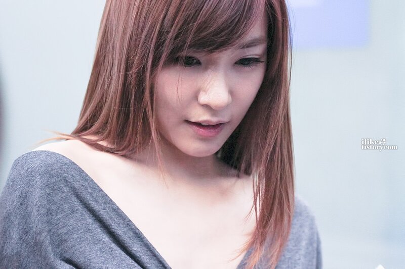woman with brown hair looking down