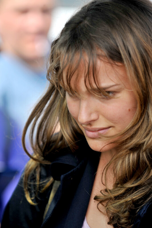 woman with brown hair looking down