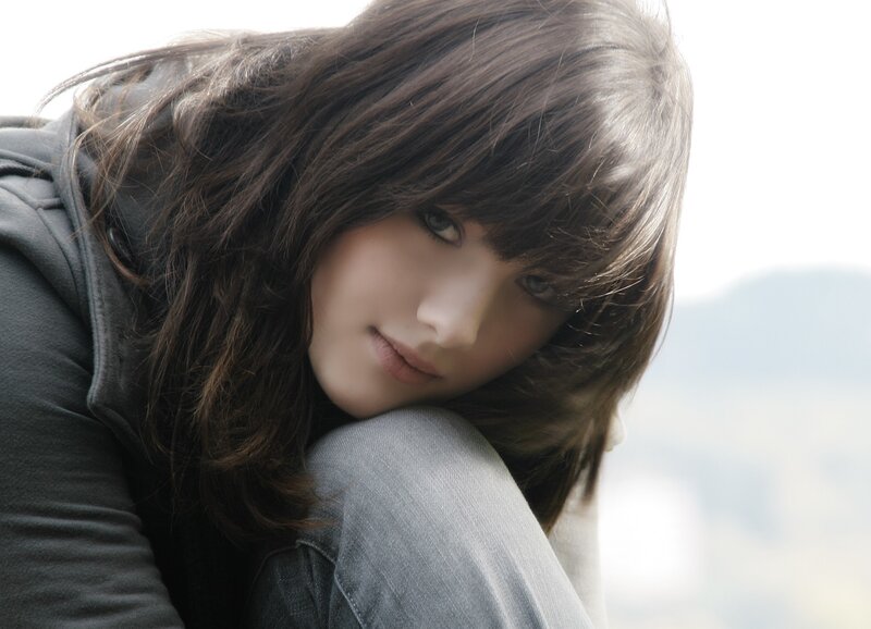 woman with brown hair looking down